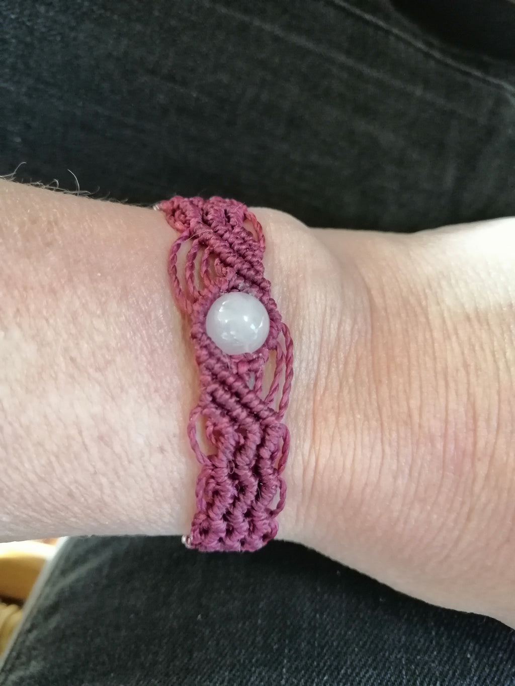 bracelet modèle @solyluna tissé a la main en micro macramé de couleur prune avec une perle en quartz rose.