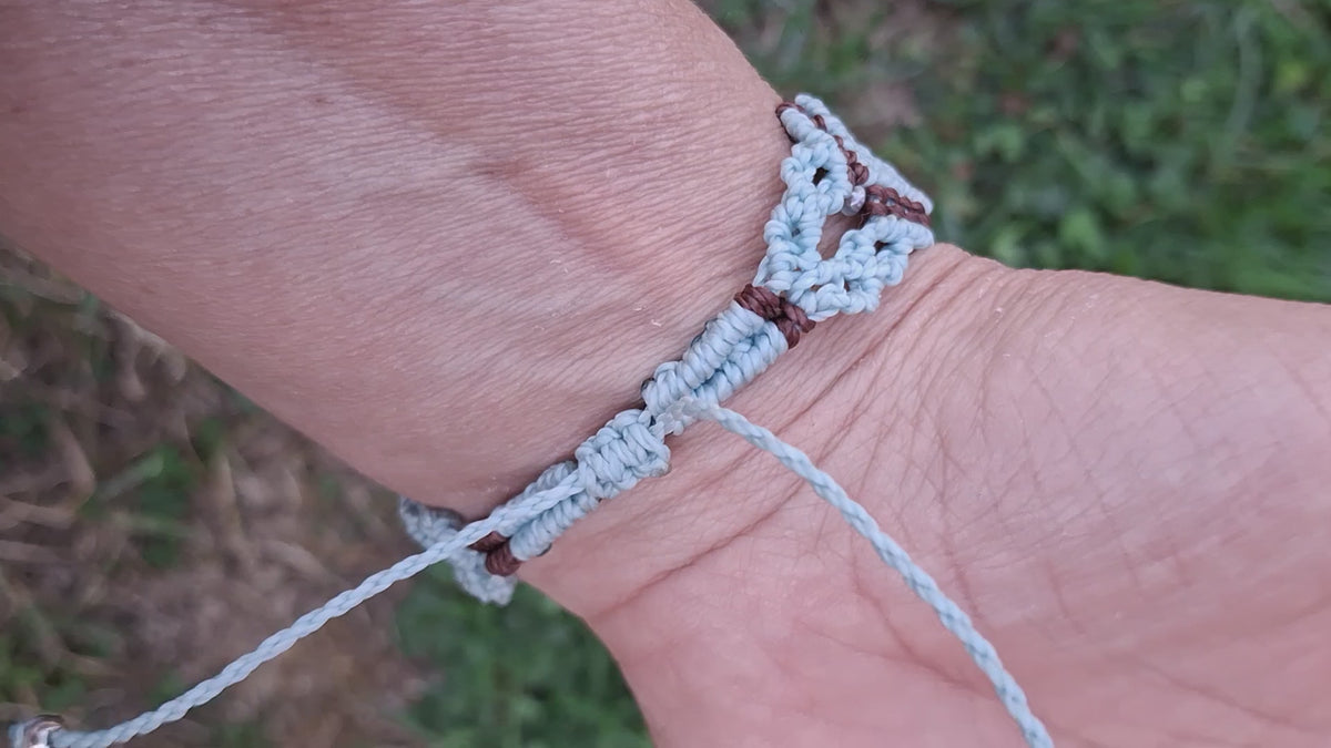 bracelet tissé à la main en micro macramé de couleur menthe et chocolat avec une perle fluorescente  en verre  bleu et des perles de rocailles fluorescente 