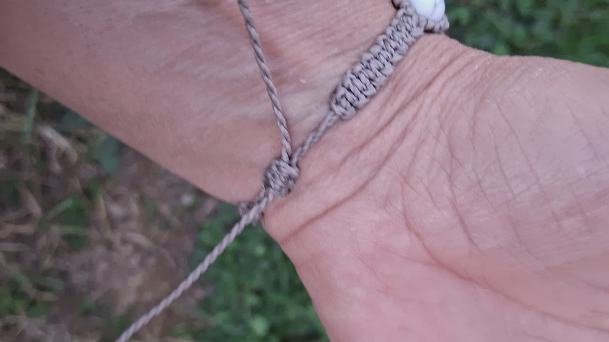 bracelet tissé à la main en micro macramé de couleur gris clair avec 5 perles en howlite ainsi que des perles en acrylique argenté